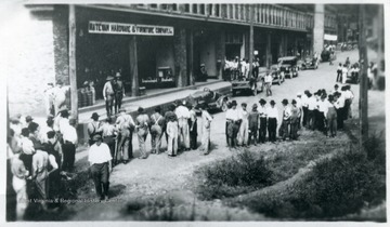 Crowd of people stand outside the Matewan Hardware and Furniture Company, Inc.