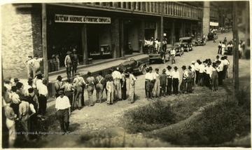 Men standing in front of Matewan Hardware and Furniture Company Inc. building.