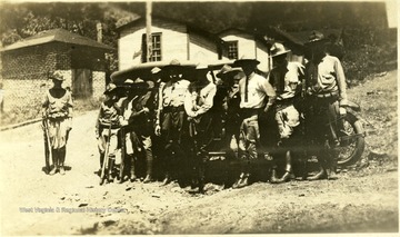 A flying squad of Mingo Militia holding guns while standing in front of a car.  "Picture used on page 588 of book."