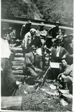 Mine guards sitting around in a group.  'Old Tony' sitting beside machine gun on right.