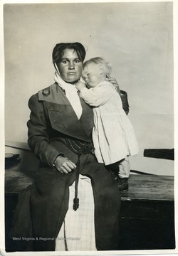 Miner's wife and child posing for a photograph.