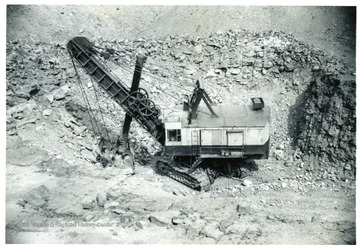 Shovel strip mining a hillside.  