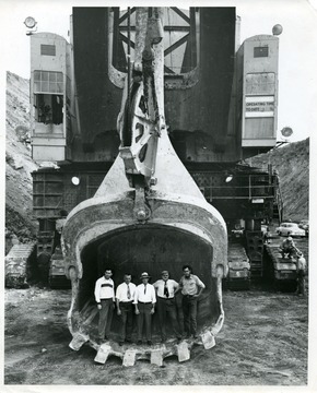 Visitors and workers standing inside of a coal shovel, possibly The Tiger.
