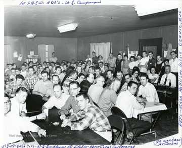 Group portrait of W.E. employees standing and seated at tables during I.B.E.W. Educational Conference. 92 workers attended.  Rep's - Mace, McAliley, Gillis, Ozanic, Ens.