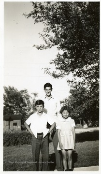 Joe Ozanic as a young man and two other children pose for a picture.