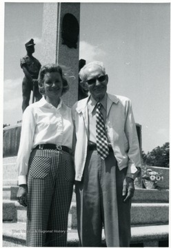 Couple standing in front of a monument at the miner's cemetery.