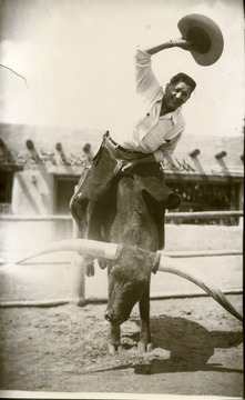 Joe Ozanic riding a bucking Long Horn Bull.