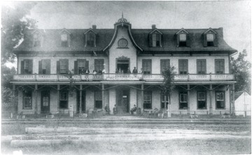 'The Alderson House Hotel was built at Alderson, West Virginia (Monroe County) in 1882 by Messrs. David J. Cogbill and John W. Alderson. It was located in close proximity to the main line iron of the Chesapeake [and] Ohio Railway. It was the most modern hotel in the state of West Virginia on the C [and] O line when it was built, having 26 rooms and two annexes, adding about 15 rooms. It was the first building in Alderson to have running water in every room, it being supplied from a 7,000 gallon tank located just above the third story of the hotel. It recieved much praise from Virginia Newspapers in the '80's who always referred to it as the best and most famous house on the C [and] O in West Virginia except for the White Sulphur Hotel. In addition to the regular guests and boarders, two C [and] O passenger trains each day stopped for meals in the hotel's dinning room. One express passenger train stopped for breakfast and one for supper, there being about 200 people from the steamcars taking meals in the fine dinning room. The Alderson House took over the passenger business which had from 1872 to 1882, been handled by the Monroe House Hotel, which was located across the street on the other side of the rails. The Alderson House continued as a eating stop on the C [and] O until the middle 1890's and after that became principally a summer resort. By 1896 the town of Alderson had huge swarms of people coming in from the Virginia and Ohio cities to spend the summer in the cool, pleasant mountains. This traffic reached a height about 1900. By 1912 there were few summer boarders. During this period the Alderson House got more than its share of the trade. It continued as a popular stop until the 1930's when rail travel slowed down considerably. The hotel operated under many different managers after Mr. J.W. Alderson gave up the management in 1905 and did not close down until 1961.'