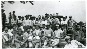 'The day is finished and refreshments are enjoyed by all. Best Union men that ever lived of No. 35, PMA, who gave their time and labor to build a memorial to clean unionship.' Miners at the Miners Cememtary, Mt. Olive, Ill.