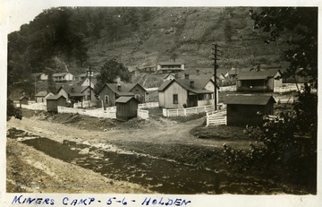Miner's housing beside a stream. Photograph from Joe Ozanic scrapbook.