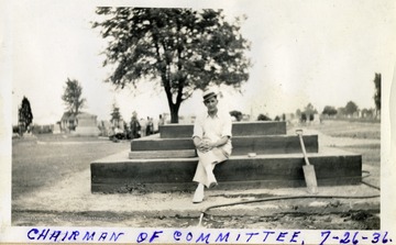 'Chairman of Committee, seated on foundation of Jones Memorial, Miners Cemetery, Mt. Olive, Ill.'