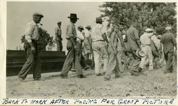 Volunteers head back to work at the Miners Cemetery, Mt. Olive, Ill. 