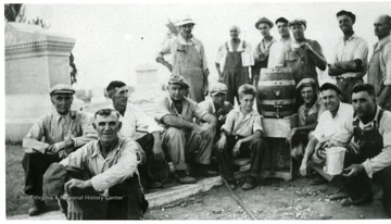 Volunteer workers gather around a barrel at the Miners Cemetary, Mt. Olive, Ill.