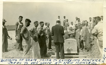 'Blessing of the grave, prior to lowering Mother Jones to new grave at new memorial.'