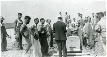 'Blessing of the grave, prior to lowering Mother Jones to new grave at new memorial.'