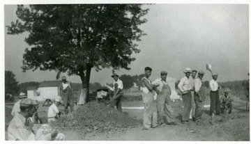 Groups of volunteer workers pause for the camera at the Miner's Cemetery, Mt. Olive, Ill.