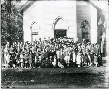 Group portrait of men, women and children on Rally Day in front of the Old Methodist Church in Alderson, West Virginia.