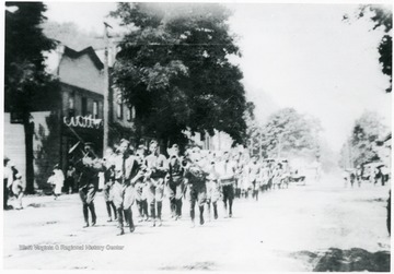 Camp Greenbrier Military Band marching in the July, 4th parade on Railroad Avenue, Alderson, W. Va.
