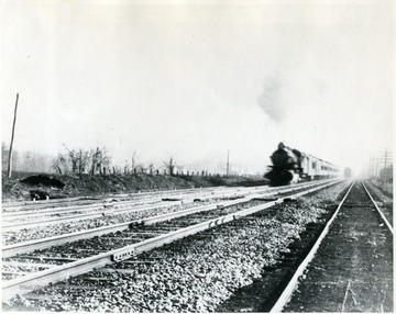 Train moving down tracks. 'Credit; Mrs. Cecile Huffman.'