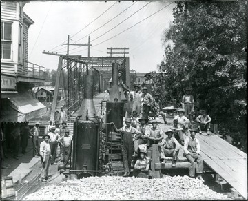 Group portrait of workers of the Concrete-Steel Bridge Company and their equipment working on 'new' Alderson Bridge.  