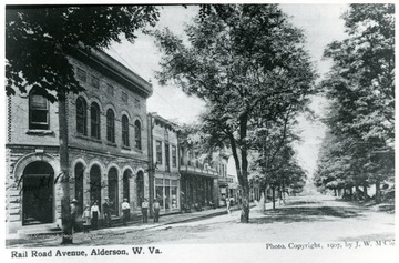 People standing outside of buildings on Railroad Avenue, South Alderson, W.Va.  'Given by Virgil Burns.'