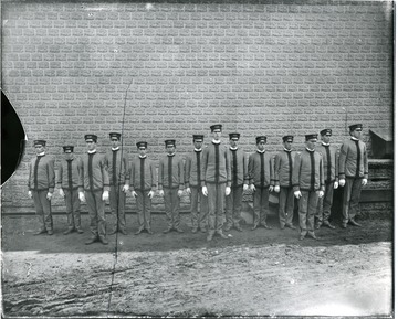Uniformed cadets standing in line.