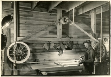 Andy Ornick, a cabinet maker, works with his sander in a shop.