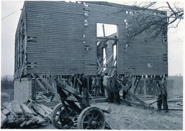 Men at work moving a truss.