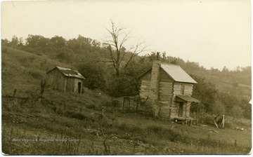 Log cabin, possibly slave cabin, with wooden shed in rear.