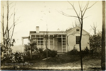 Unplanted shrubs in front of a house in Arthurdale.