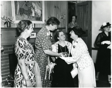 Eleanor Roosevelt speaks with ladies attending a reception at Arthurdale Inn in Arthurdale W. Va.