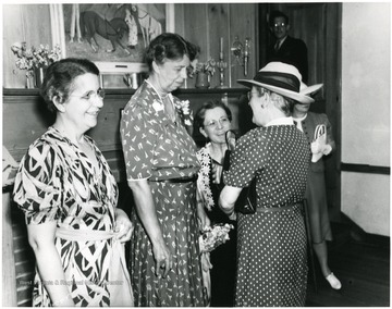 Eleanor Roosevelt speaks with ladies attending a reception at Arthurdale Inn in Arthurdale W. Va.
