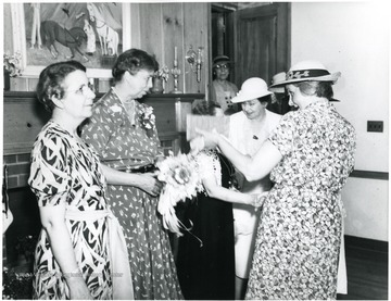 Eleanor Roosevelt converses with ladies attending a reception at Arthurdale Inn in Arthurdale, W. Va