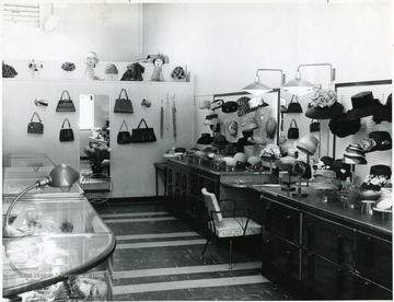 Hats and wigs on display at Newlands Millinery. 'Mrs. Anna D. Newland, 119 Main St.'