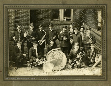 Group portrait of band members.'I, Harlow Warren, was a member of this 2nd band organized in Beckley by John Irwin (not in the picture) for the Moose Club 1606 Beckley lodge. 3rd from left Bert Hawley, 5th, Deering, behind the drum is Alden Sampson, son of Dr. Sampson; other not recognized immediately. Lower left front, John Brezack, deceased.'