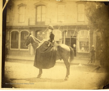 A portrait of a woman on a horse.