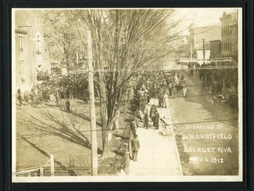 Crowds gathered outside a building to hear Dr. H.D. Hatfield speak at Beckley, West Virginia, in November 1912. Banner reading 'Republican Headquarters' hanging over the street.