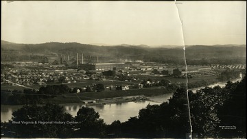 View of South Charleston, West Virginia in 1921. Factories and homes visible along river.