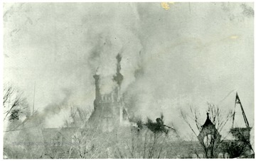 From a postcard. The top of the W. Va. State Capitol building engulfed in flames.