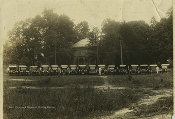Physicians stand next to their cars in Clarksburg, W. Va. 'Left to right: 1. Esker, 2. Lynch, 3. Carbin, 4. D.B. Davis, 5. Dhrutleworth, 6. Unknown, 7. Corder, 8.Unknown, 9. E. N. Flowers, 10. Sloan, 11. Slatter, 12. Unknown, 13. Nutter, 14. Unknown, 15. Showalter, 16. A. L. Post.'