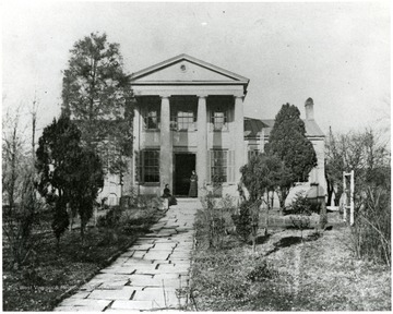 Home of Waldo P. Goff.  Large house with columns.  Two women visible on the front porch.