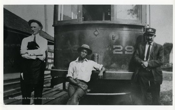 Three streetcar workers pose in front of a streetcar in Clarksburg, West Virginia.