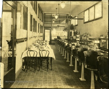 Interior view of restaurant in Clarksburg.  Tables on the right side and bar on the left.