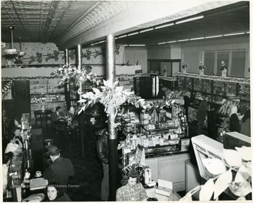 Customers are shopping in Neale's Drug Store on Daivs and Third Streets in Elkins, West Virginia.