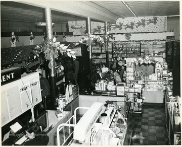 Customers are shopping in Neale's Drug Store, on Davis and Third Streets, in Elkins, West Virginia.