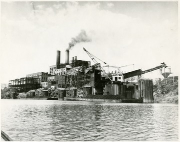 'Monongahela Power Company's multi-million dollar power station at Rivesville near Fairmont is typical of the industrial renaissance which has occured in the valley in four decades. The station went into service in 1916-17 and has grown continuously the last turbine-generator going 'on the line' three years ago. Total capability is in excess of 300,000 kw. The station is interconnected with other Monongahela facilities and with other companies stretching across the nation. R. T. Payne is the manager.'