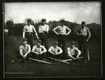 Baseball team members pose for a group portrait. 