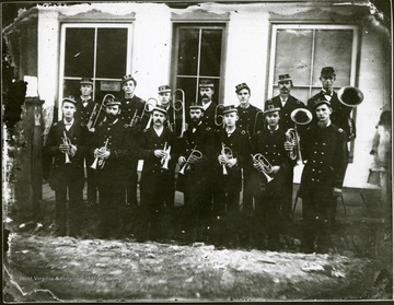 Group portrait men in uniform with brass musical instruments.