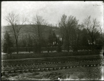 View of the National Cemetery from across railroad tracks.  Small gravestones visible.  Grafton, W. Va.