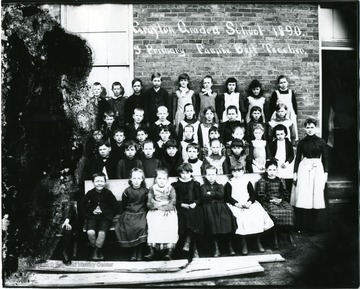 Group portrait of grade school children.  'S. Primary Fannie Best Teacher.'  